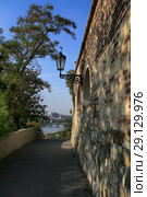 Prague, Czech Republic, Old wall and a lantern in the park Visegrad overlooking Pradsky Castle and trees (2018 год). Стоковое фото, фотограф Яна Королёва / Фотобанк Лори