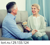 friendly mature married couple in house are warmly reconciled after quarrel. Стоковое фото, фотограф Яков Филимонов / Фотобанк Лори