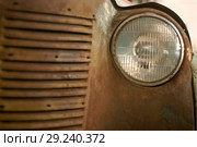 Fragment of the front of a rusted vintage car, part of the radiator and headlight. Стоковое фото, фотограф Евгений Харитонов / Фотобанк Лори