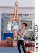 Man and woman doing acrobatic exercises in gym. Стоковое фото, фотограф Яков Филимонов / Фотобанк Лори