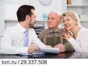 Woman and eldery man with bank employee. Стоковое фото, фотограф Яков Филимонов / Фотобанк Лори