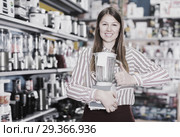 Smiling girl seller showing liquidiser in shop. Стоковое фото, фотограф Яков Филимонов / Фотобанк Лори