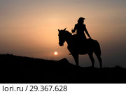 Silhouette of a horsewoman on a horse at sunset. Стоковое фото, фотограф Яна Королёва / Фотобанк Лори