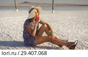 happy smiling girl enjoying the sunset, eating watermelon, sit on salt, pillars. Стоковое видео, видеограф Ирина Мойсеева / Фотобанк Лори