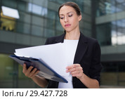 Serious businesswoman is dissatisfied of the results of the financial report. Стоковое фото, фотограф Яков Филимонов / Фотобанк Лори