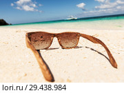wooden sunglasses lying on the beach. Стоковое фото, фотограф Иван Михайлов / Фотобанк Лори