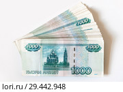 Пачка тысячных купюр на белом фоне. Стоковое фото, фотограф Сайганов Александр / Фотобанк Лори