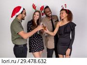 A group of friends celebrate the new year and clink glasses of champagne. Стоковое фото, фотограф Женя Канашкин / Фотобанк Лори