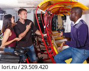 Positive people planning trip on pedicab. Стоковое фото, фотограф Яков Филимонов / Фотобанк Лори