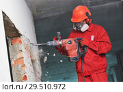 worker with demolition hammer breaking interior wall. Стоковое фото, фотограф Дмитрий Калиновский / Фотобанк Лори
