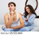 Smiling girl trying to comfort upset husband. Стоковое фото, фотограф Яков Филимонов / Фотобанк Лори