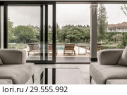Modern interior with large glass door and windows. Стоковое фото, фотограф Andriy Bezuglov / Фотобанк Лори