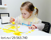 Cute lovely little girl painting with foam brush at home. Стоковое фото, фотограф ivolodina / Фотобанк Лори