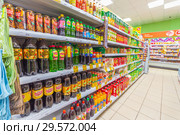 Russia, Samara, November 2018: a bottle of soft drinks in the supermarket. Text in Russian: lemonade, Russian kvass, tea, pear, barberry, action, lemon, sea buckthorn, green. Редакционное фото, фотограф Акиньшин Владимир / Фотобанк Лори