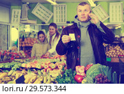 Man specifying shopping list in store. Стоковое фото, фотограф Яков Филимонов / Фотобанк Лори