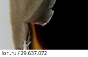 Burning paper through the center on a black background. Стоковое видео, видеограф Dzmitry Astapkovich / Фотобанк Лори