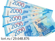 Российские деньги. Новые купюры номиналом 2000 рублей на белом фоне. Стоковое фото, фотограф Елена Коромыслова / Фотобанк Лори