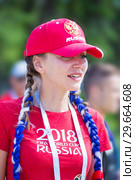 Russia, Samara, June 2018: beautiful football cheerleader smiling at the World Cup. Редакционное фото, фотограф Акиньшин Владимир / Фотобанк Лори