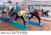 Happy adults having group fitness class. Стоковое фото, фотограф Яков Филимонов / Фотобанк Лори