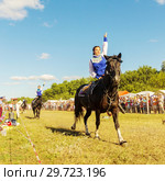 Russia, Samara, July, 2018: Cossack girls ride horses and perform tricks. Редакционное фото, фотограф Акиньшин Владимир / Фотобанк Лори