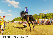 Russia, Samara, July, 2018: a Cossack girl rides a horse and performs tricks. Редакционное фото, фотограф Акиньшин Владимир / Фотобанк Лори