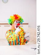 Male clown preparing for perfomance at home. Стоковое фото, фотограф Elnur / Фотобанк Лори