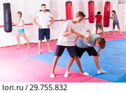 Kids practicing in pair self-protection. Стоковое фото, фотограф Яков Филимонов / Фотобанк Лори