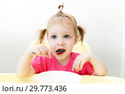 Cute little girl eating soup at home kitchen. Стоковое фото, фотограф ivolodina / Фотобанк Лори