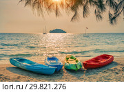 Colored plastic boats on sandy beach at sunset, Sihanoukville, Cambodia (2013 год). Стоковое фото, фотограф Юлия Бабкина / Фотобанк Лори