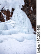 Frozen ice on rocks from a waterfall in the mountains. Стоковое фото, фотограф Restyler Viacheslav / Фотобанк Лори
