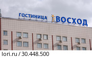 Вывеска гостиницы "Восход" на фасаде здания на фоне неба. Москва, Алтуфьевское шоссе 2 (2019 год). Редакционное фото, фотограф Наталья Николаева / Фотобанк Лори