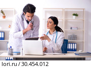 Two young doctors working in the clinic. Стоковое фото, фотограф Elnur / Фотобанк Лори
