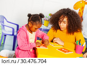 Girl in nursery school learning to button unbutton. Стоковое фото, фотограф Сергей Новиков / Фотобанк Лори