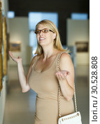 Woman throwing up hands near picture. Стоковое фото, фотограф Яков Филимонов / Фотобанк Лори