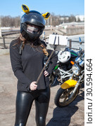 Woman motorcyclist in helmet with ears taking selfies using cellphone with extensible monopod stick. Стоковое фото, фотограф Кекяляйнен Андрей / Фотобанк Лори