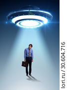 Flying saucer abducting young businessman. Стоковое фото, фотограф Elnur / Фотобанк Лори