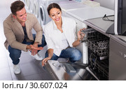 Ordinary young customers choosing new dish washing machine. Стоковое фото, фотограф Яков Филимонов / Фотобанк Лори