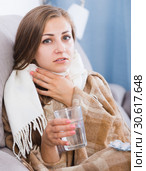 Sick girl on sofa taking drugs. Стоковое фото, фотограф Яков Филимонов / Фотобанк Лори