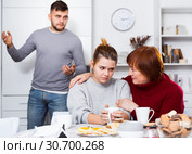 Woman asking upset girl to forgive son after quarrel. Стоковое фото, фотограф Яков Филимонов / Фотобанк Лори