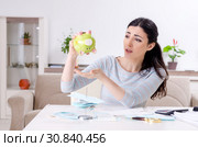 Young woman in budget planning concept. Стоковое фото, фотограф Elnur / Фотобанк Лори