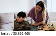 Upset mother and offended son arguing in domestic interior. Стоковое видео, видеограф Яков Филимонов / Фотобанк Лори