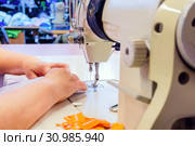 Industrial overlock sewing machine in work. Стоковое фото, фотограф Евгений Харитонов / Фотобанк Лори