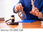Young male judge sitting in courtroom. Стоковое фото, фотограф Elnur / Фотобанк Лори