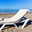 Concept of rest by the sea - lounger with beach towel and child walking to sea. Стоковое фото, фотограф Светлана Кузнецова / Фотобанк Лори