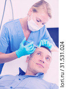 Female specialist is doing injection to client for anti-aging. Стоковое фото, фотограф Яков Филимонов / Фотобанк Лори