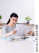 Young woman in budget planning concept. Стоковое фото, фотограф Elnur / Фотобанк Лори