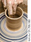 Potter's hand mold pottery on a rotating wheel. Стоковое фото, фотограф Евгений Харитонов / Фотобанк Лори