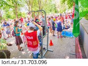 Russia Samara June 2019: a girl passes the standards for pulling up on a horizontal bar in the park sunny day. Text in Russian: Judge Gto. Редакционное фото, фотограф Акиньшин Владимир / Фотобанк Лори