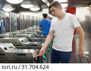 Passenger near baffle gate in underground. Стоковое фото, фотограф Яков Филимонов / Фотобанк Лори