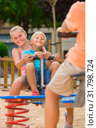 Children are teetering on the swing. Стоковое фото, фотограф Яков Филимонов / Фотобанк Лори